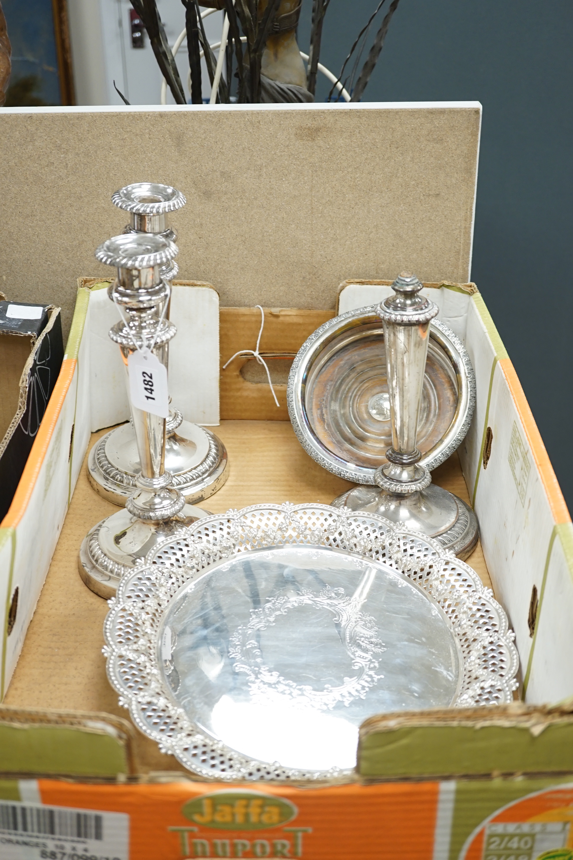 Plated wares: a pair of wine coasters, two ornate basket-edged dishes, a sugar bowl, three candlesticks, three candleholders, a teapot, ice bucket cased serving spoons and a metal mounted glass decanter.